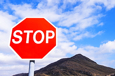 Stop Sign Against A Bright Blue Sky And Mountain Range In Killarney National Park, County Kerry, Ireland