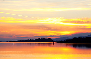 A Dramatic And Colourful Sunset Reflected In Water With Silhouetted Shoreline And Mountains, Kenmore, County Kerry, Ireland