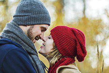 A Young Couple Looking Into Each Other's Eyes And Kissing In A City Park In Autumn, Edmonton, Alberta, Canada