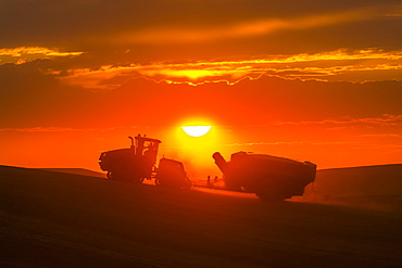 Case Quadtrac Tractor Pulling A Grain Cart In A Wheat Field During Harvest In The Palouse Region Of Eastern Washington, Washington, United States Of America