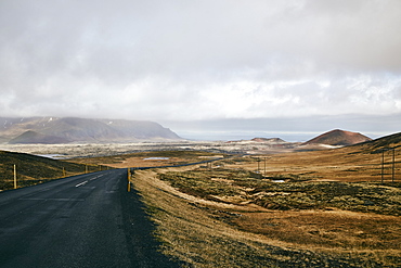 An Asphalt Road Along The Coast Under A Cloudy Sky, Iceland