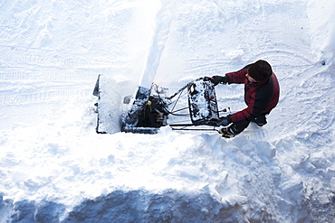 Directly Above A Man Using A Snowblower, Homer, Alaska, United States Of America