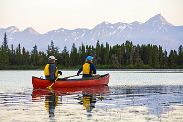 A Couple Canoeing On Stone Step Lake, Homer, Alaska, United States Of America