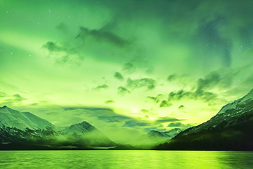 Bright Green Aurora Borealis Dances Over Upper Trail Lake, The Kenai Mountains In The Background, Moose Pass, Kenai Peninsula, South-Central Alaska, Alaska, United States Of America