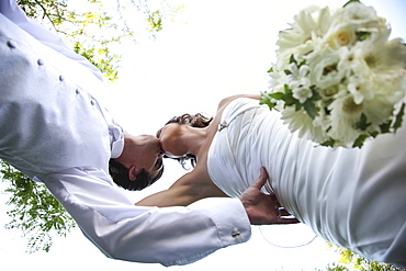 Low Angle View Of A Bride And Groom Kissing On The Wedding Day, Ontario, Canada