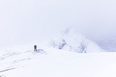 A Hiker Climbs A Ridge High Above Trims Creek In A Portion Of The Alaska Range Known As The 'delta Mountains' In Early Winter, Alaska, United States Of America