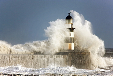 Seaham, Teesside, England; Waves Crashing Into A Lighthouse