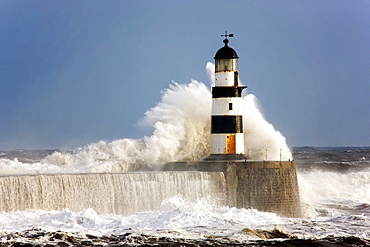 Seaham, Teesside, England; Waves Crashing Against A Lighthouse