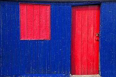 St. Abb's Head, Scottish Borders, Scotland; A Red Door And Window On A Blue Wooden Building