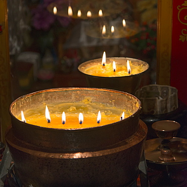 Flames burning in a row in large bronze pots, Lhasa xizang china