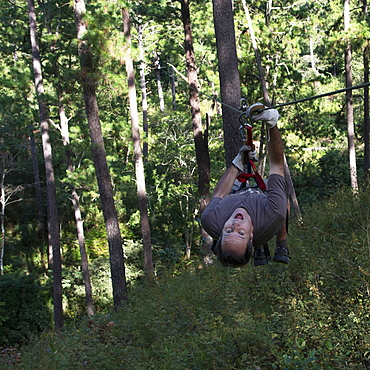 A Man Hangs Upside Down On A Zip-Line, Copan, Honduras