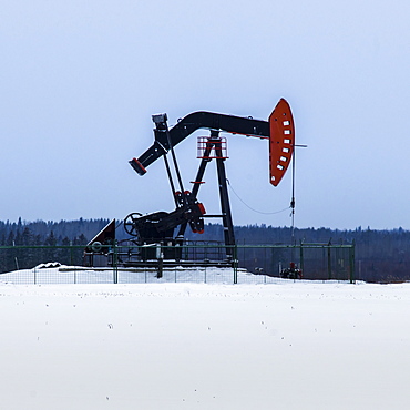 A Pumpjack In A Field Covered In Snow, Alberta, Canada