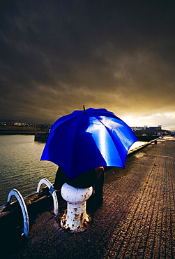 Person With Umbrella In Stormy Skies