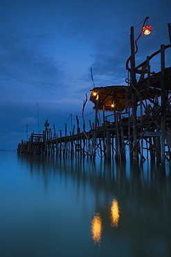 Lights On A Wooden Pier Leading Out In The Water At Night, Kho Samet, Thailand