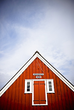 A Red Wooden Building With Shutters On The Window And A Peaked Rooftop, Papey Island, Iceland