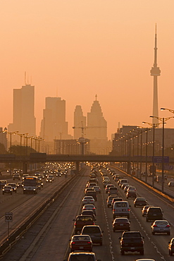 View Of Toronto Skyline From Above Queen Elizabeth Way Highway During Start Of Rush Hour Traffic, Toronto, Ontario, Canada.