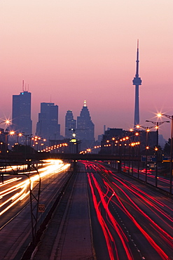 View Of Toronto Skyline From Above Queen Elizabeth Way Highway During Start Of Rush Hour Traffic, Toronto, Ontario, Canada.