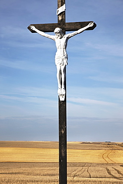 Crucifix and a farm field in the background, Saskatchewan canada