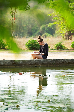 Girl painting beside a lake, Chiang mai thailand