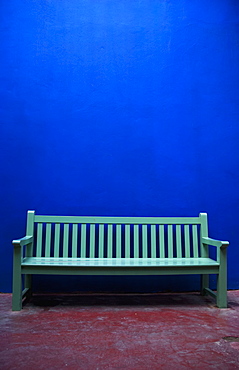 A painted green bench along a blue wall, Marrakech, morocco