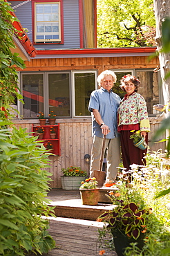 Senior Couple Standing In Their Home Garden, Winnipeg Manitoba Canada