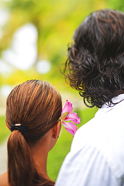 The back of the heads of a man and woman the woman having a flower in her hair bora bora nui resort and spa, Bora bora island society islands french polynesia south pacific