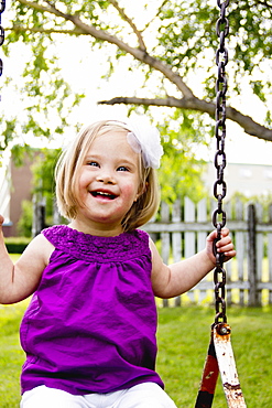 Young Girl With Down Syndrome On A Swing, Three Hills, Alberta, Canada