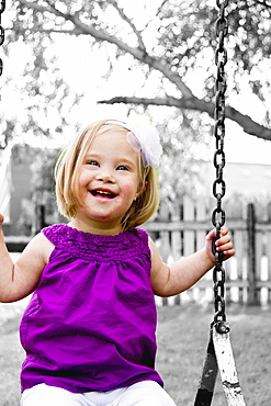 Young Girl With Down Syndrome On A Swing, Three Hills, Alberta, Canada