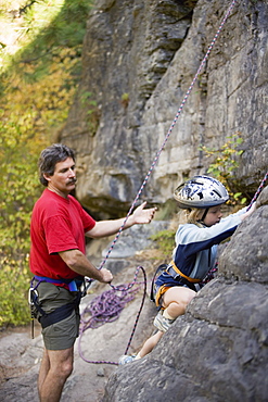 Young Girl (Age 7) Preparing To Climb While Father Belays At Stone Hills Near Rexford, Montana, Usa