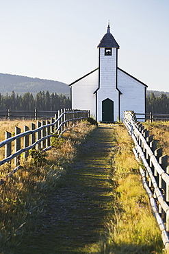 Old Wooden Church In Foothills With Wooden Fence And Blue Sky, Cochrane, Alberta, Canada