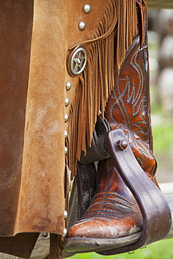 Close-Up Of A Cowboy Boot In The Stirrups, Alberta, Canada