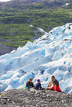 Couple With Daughter Having A Snack Overlooking A Glacier, Shoup Bay State Marine Park, Prince William Sound, Valdez, Alaska, United States Of America