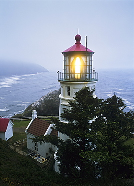 The Heceta Head Lighthouse Flashes On A Foggy Morning, Florence, Oregon, United States Of America