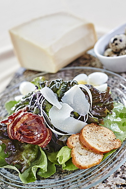 Salad With Shaved Parmesean Cheese, Bacon, Bread Crisps, And Quail Eggs, Ontario, Canada