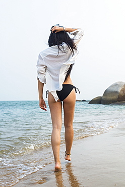 Young Woman Walking On The Beach In A Bikini, Xiamen, China