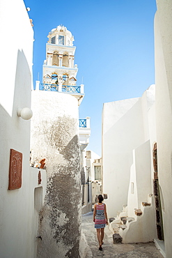 A Woman Walks Between Whitewash Buildings, Megalochori, Santorini, Greece