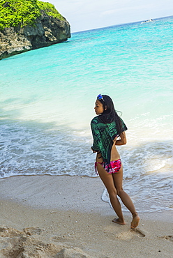 Young Woman Enjoys Walking On The Sand Of Puka Beach, Borakay, Panay, Philippines