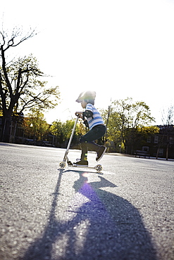 Young Boy Riding A 2-Wheeled Scooter, Montreal, Quebec, Canada