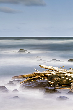 Driftwood And Rocks Along The Coast Of Lydgate Beach Park, Lydgate, Kauai, Hawaii, United States Of America