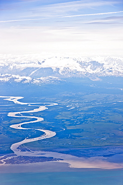 Aerial View Of A Winding River Connecting Snow-Capped Mountains To Cook Inlet, Southcentral Alaska, USA, Summer