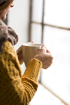 Nicaraguan Woman Holding A Cup Of Tea And Looking Out The Window, Toronto, Ontario, Canada