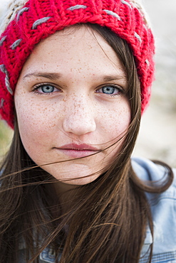 Portrait Of A Young Woman With Freckles, Blue Eyes And Long Brown Hair, Tarifa, Cadiz, Andalusia, Spain