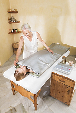 A Young Woman Laying On A Treatment Table At A Spa Getting A Treatment, Tarifa, Cadiz, Andalusia, Spain