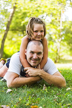 A Father And Daughter Posing And Spending Quality Time Together In A Park During A Family Outing, Edmonton, Alberta, Canada