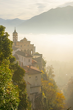 Fog Sets In Over A Church And Alpine Lake, Locarno, Ticino, Switzerland