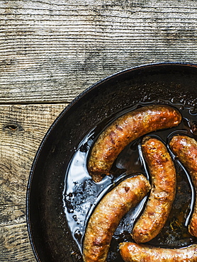 Fried Homemade Sausages In Pan On Old Weathered Wooden Table, Kiev, Ukraine