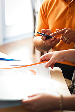 Man And Woman With Documents And A Calculator, Regina, Saskatchewan, Canada