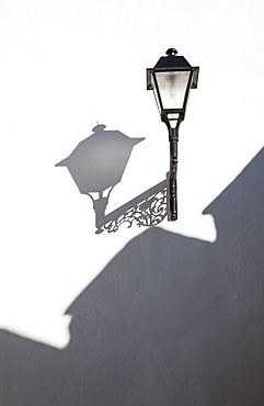 A Light Mounted On A White Wall With Shadows Cast, Conil De La Frontera, Andalusia, Spain