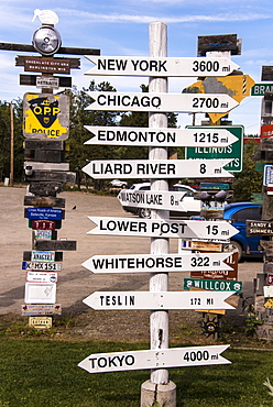 Signpost forest displaying numerous destination and distance signs, Watson Lake, Yukon, Canada