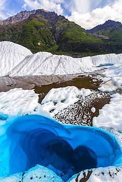 A pool of water on the surface of Root Glacier in Wrangell-St. Elias National Park resembles a heart shape, Alaska, United States of America